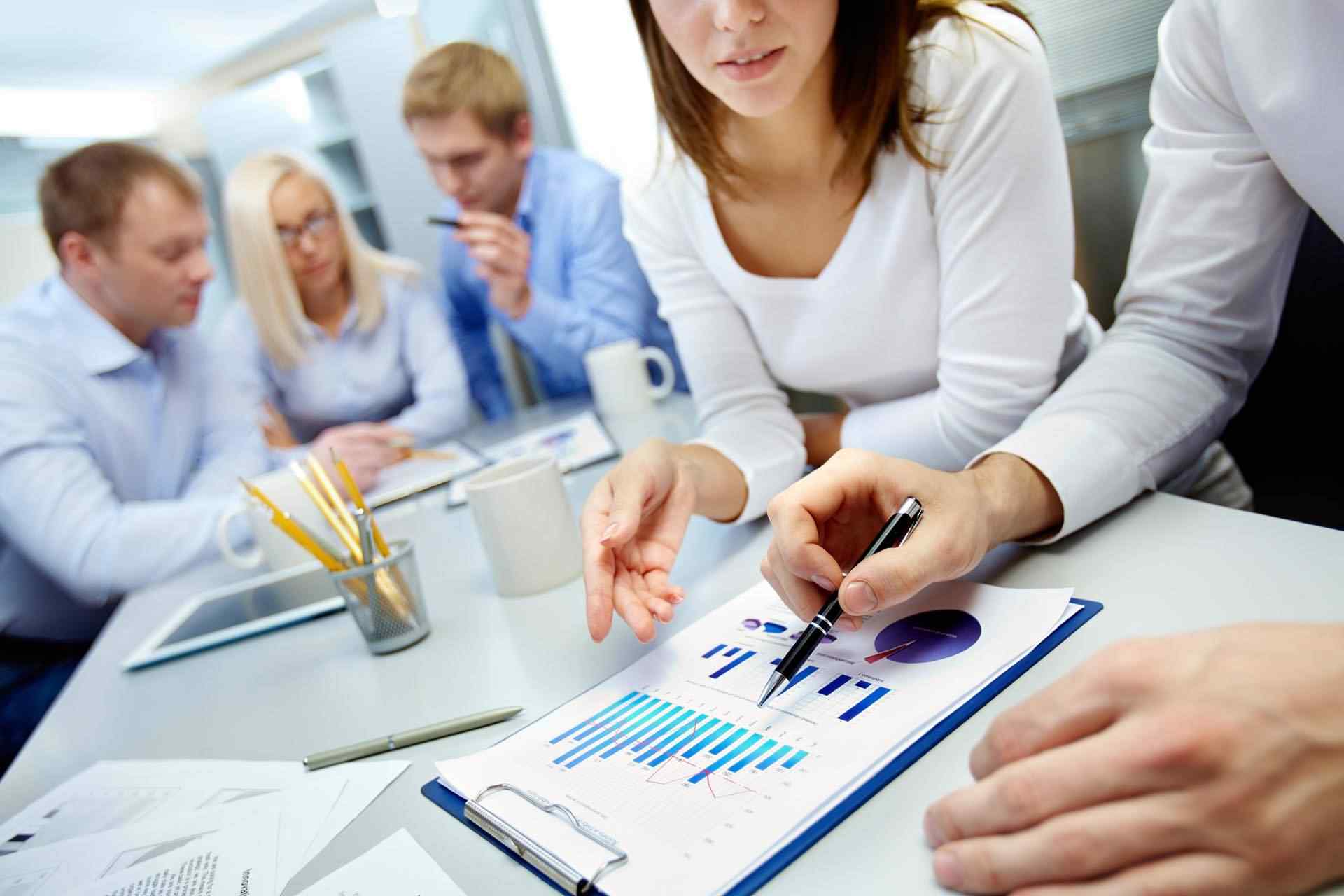 Business lunch. Business people sitting at table at restaurant looking at each other discussing